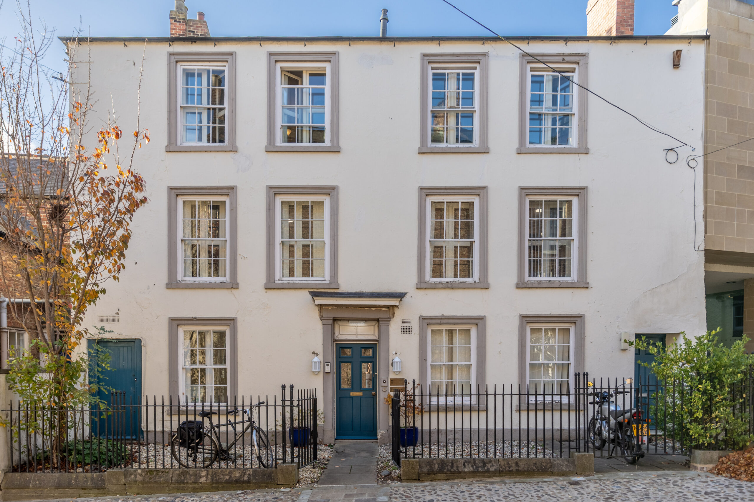 a Georgian house with a blue door and eleven windows